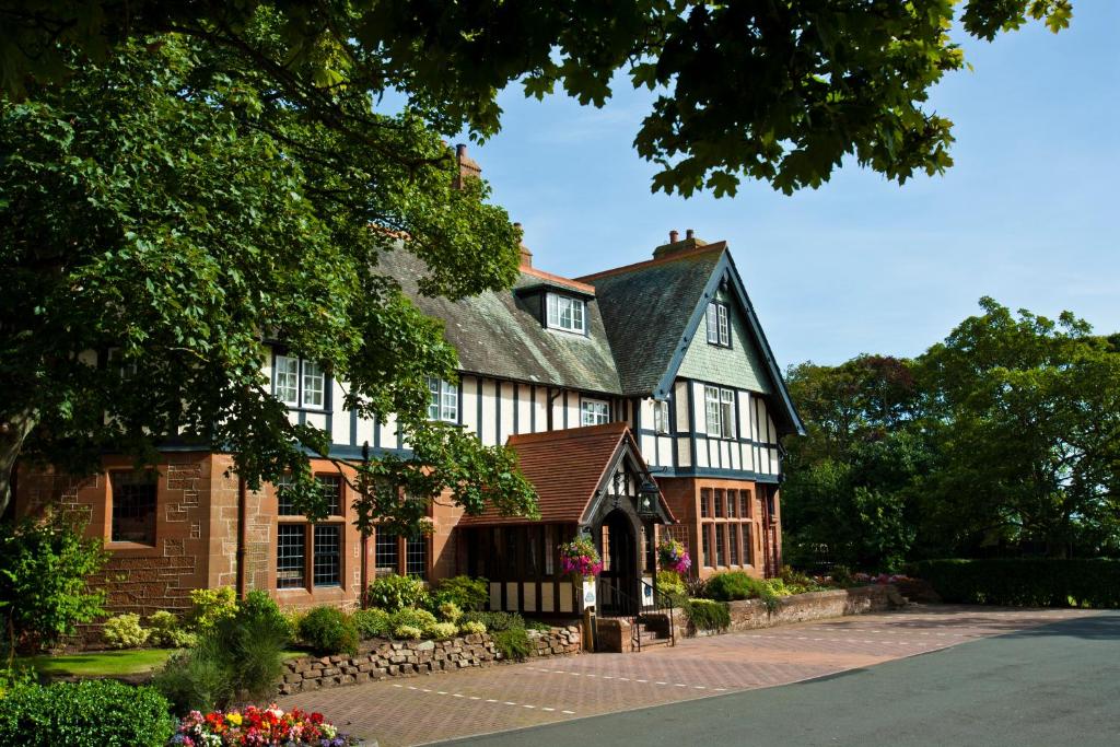 uma casa grande com um branco e castanho em Piersland House em Troon