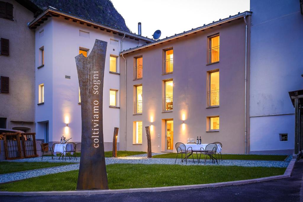 a building with a sign in front of it at coltiviamo-sogni in Campascio