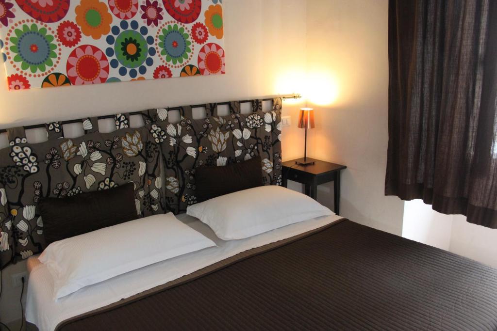 Łóżko lub łóżka w pokoju w obiekcie San Lorenzo Rooms