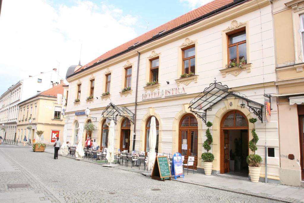 a building on a street in a city at Hotel Istra in Varaždin