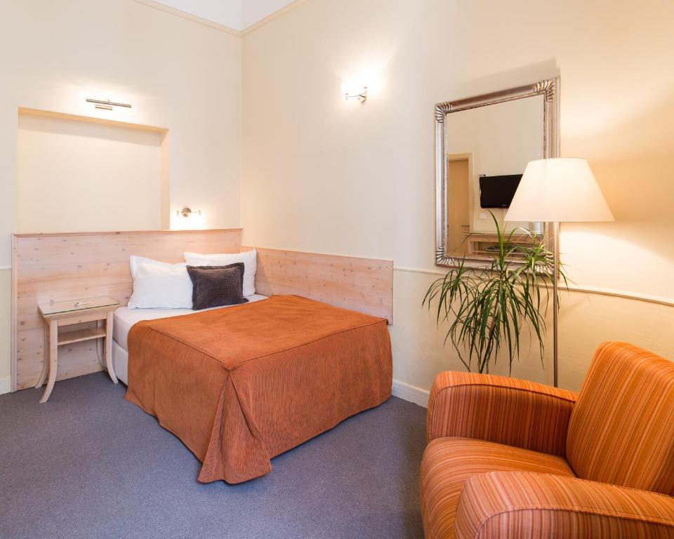 Postel nebo postele na pokoji v ubytování Unitas Hotel