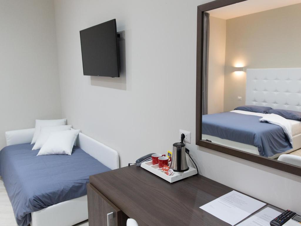 Postel nebo postele na pokoji v ubytování Venustas Roma Hotel