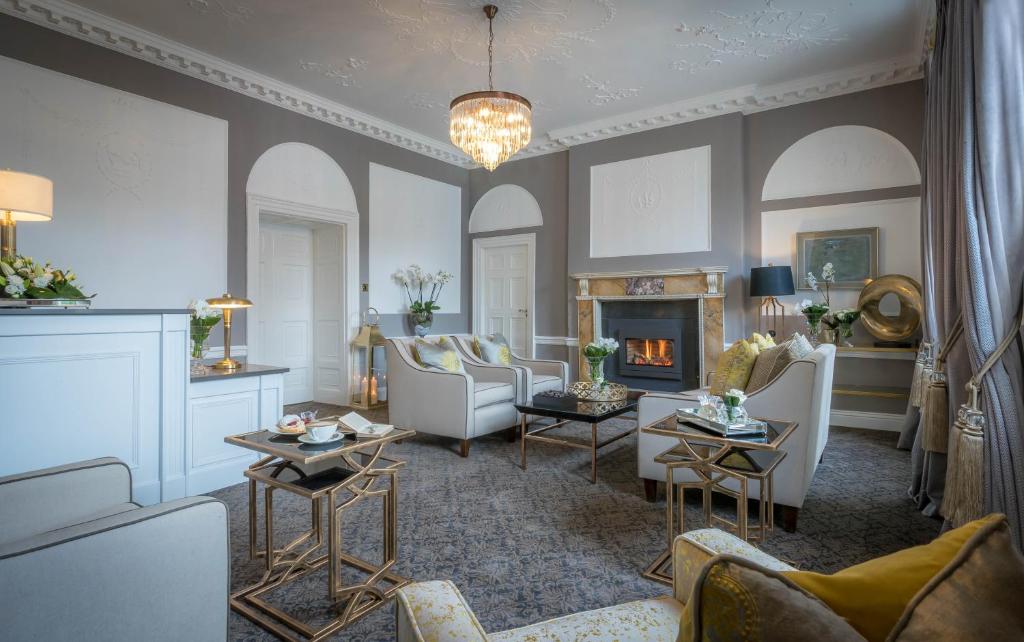 a living room with couches and a fireplace at Butler House in Kilkenny