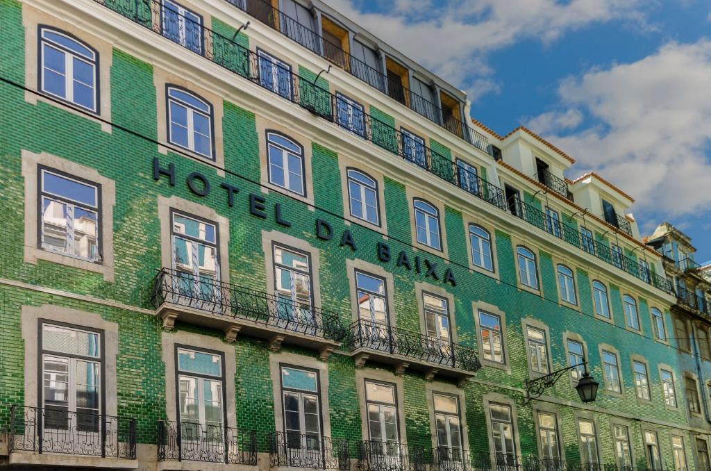 un bâtiment vert avec un panneau sur son côté dans l'établissement Hotel da Baixa, à Lisbonne