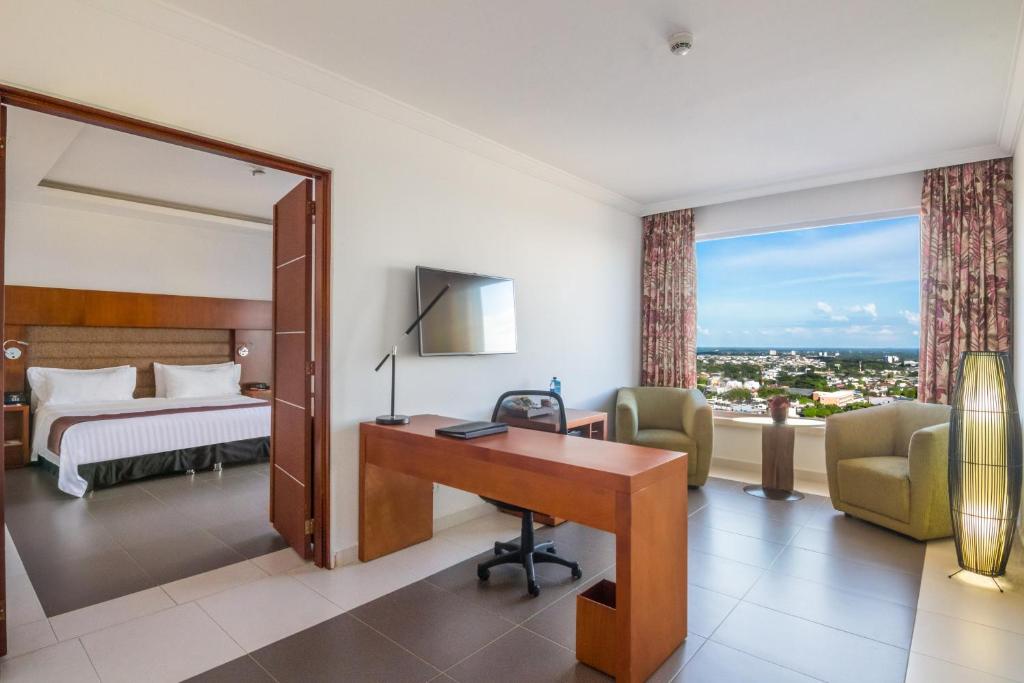Postel nebo postele na pokoji v ubytování GHL Hotel Grand Villavicencio