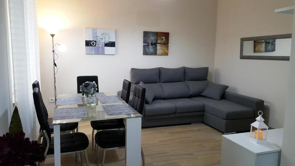 a living room with a couch and a table at Eduardo Lucena 5, Flamenco in Córdoba