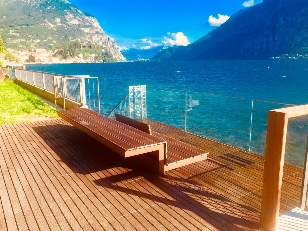 a bench sitting on a deck overlooking the water at I Bravi in Malgrate