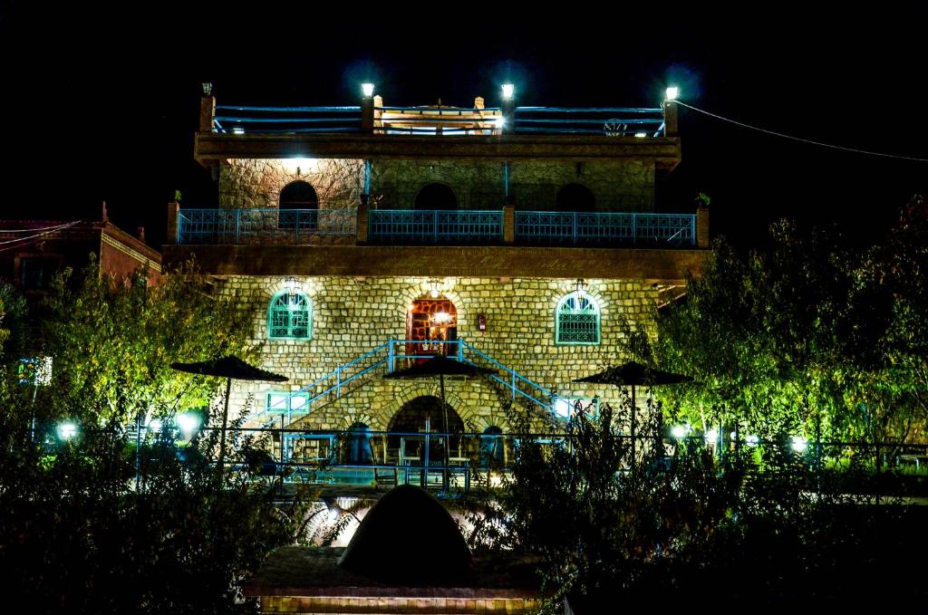 a building with lights on it at night at Riad Aslda in Asni