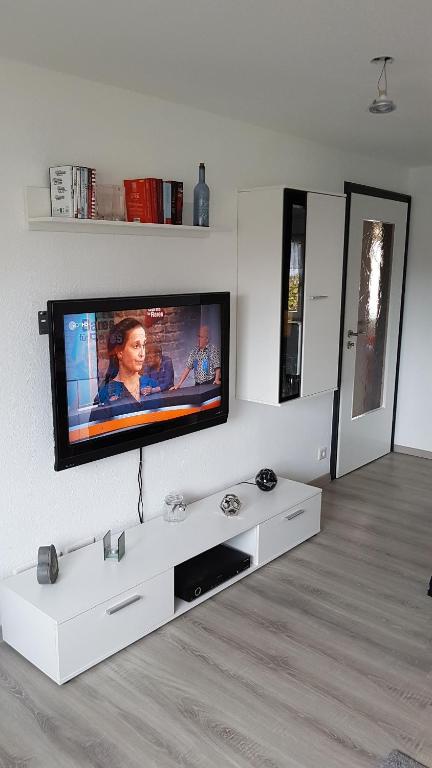 a living room with a flat screen tv on a wall at Casa del Sol in Kleve