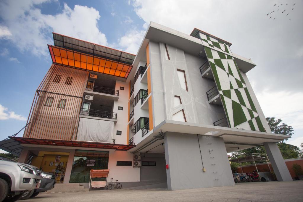 a tall white building with a lot of windows at STAY MAYB Chiang Mai in Chiang Mai