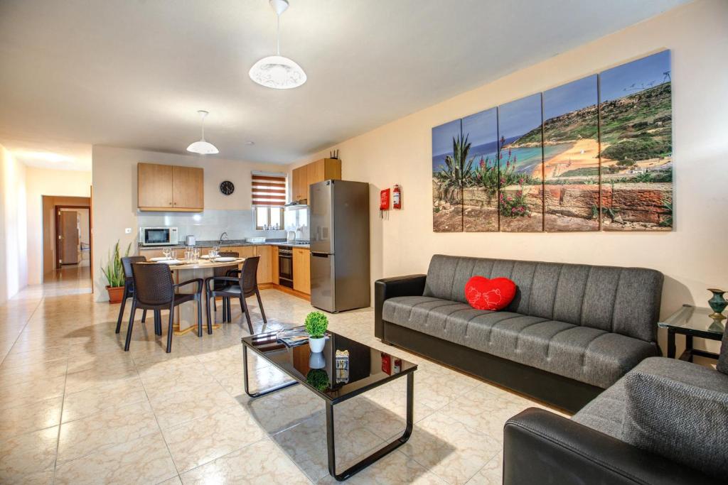 a living room with a couch and a table at Victoria Penthouse in Victoria