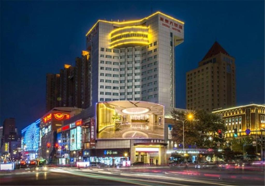 a large building in a city at night at Changchun Ya Tai Hotel in Changchun