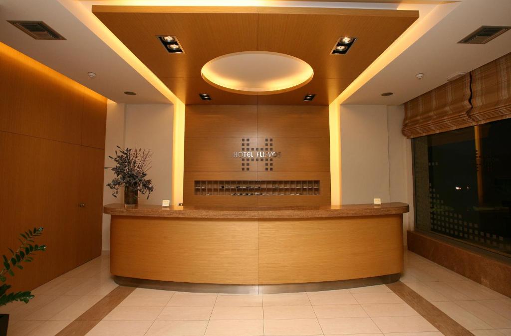 a waiting room with a counter in a building at Hotel Flisvos in Kalamata