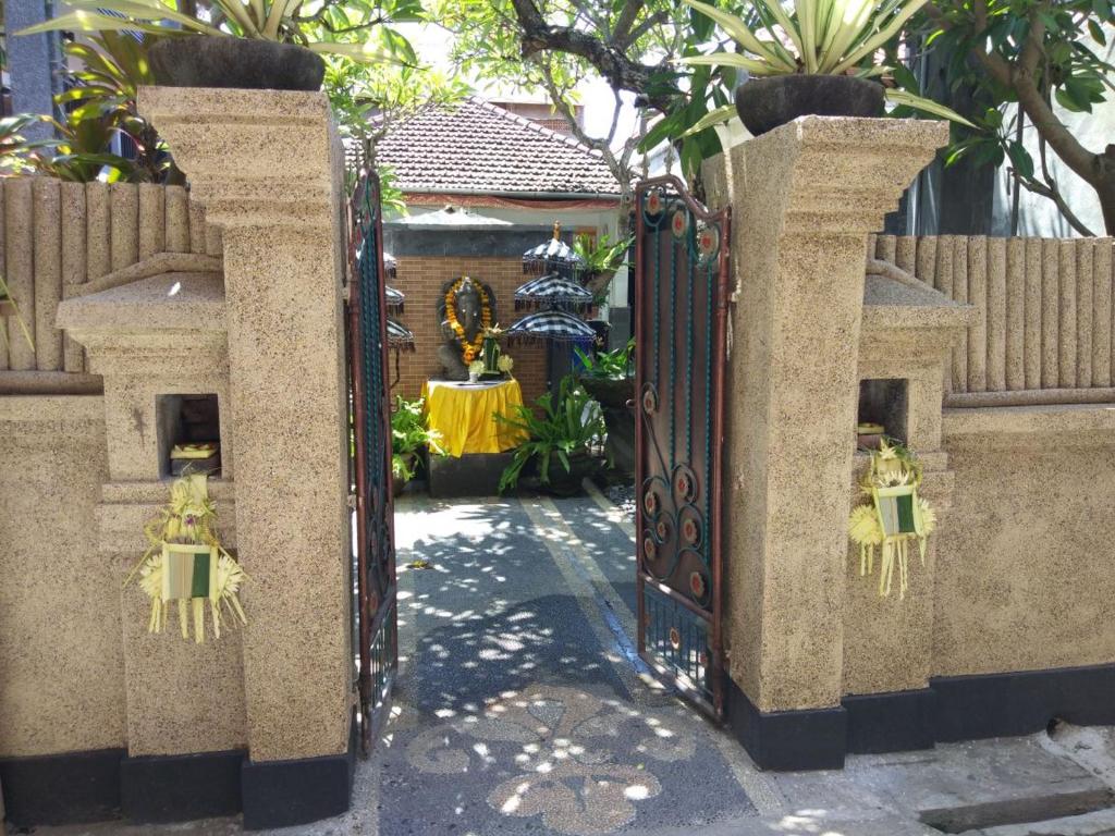 an entrance to a garden with an open gate at Tirta Yoga Inn in Padangbai
