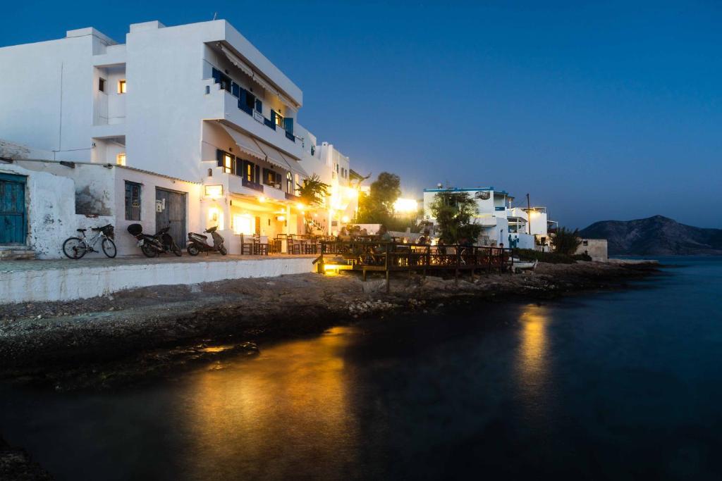 un edificio junto a un cuerpo de agua por la noche en To Kima, en Koufonisia