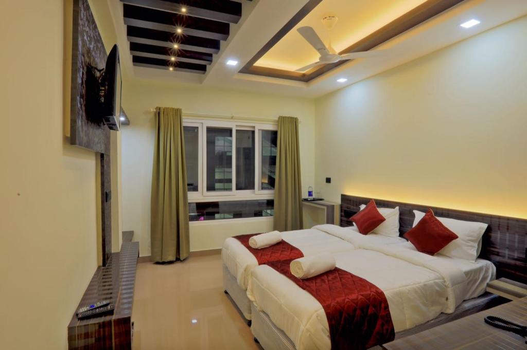 a bedroom with a large bed and a window at Kenz Residency in Cochin