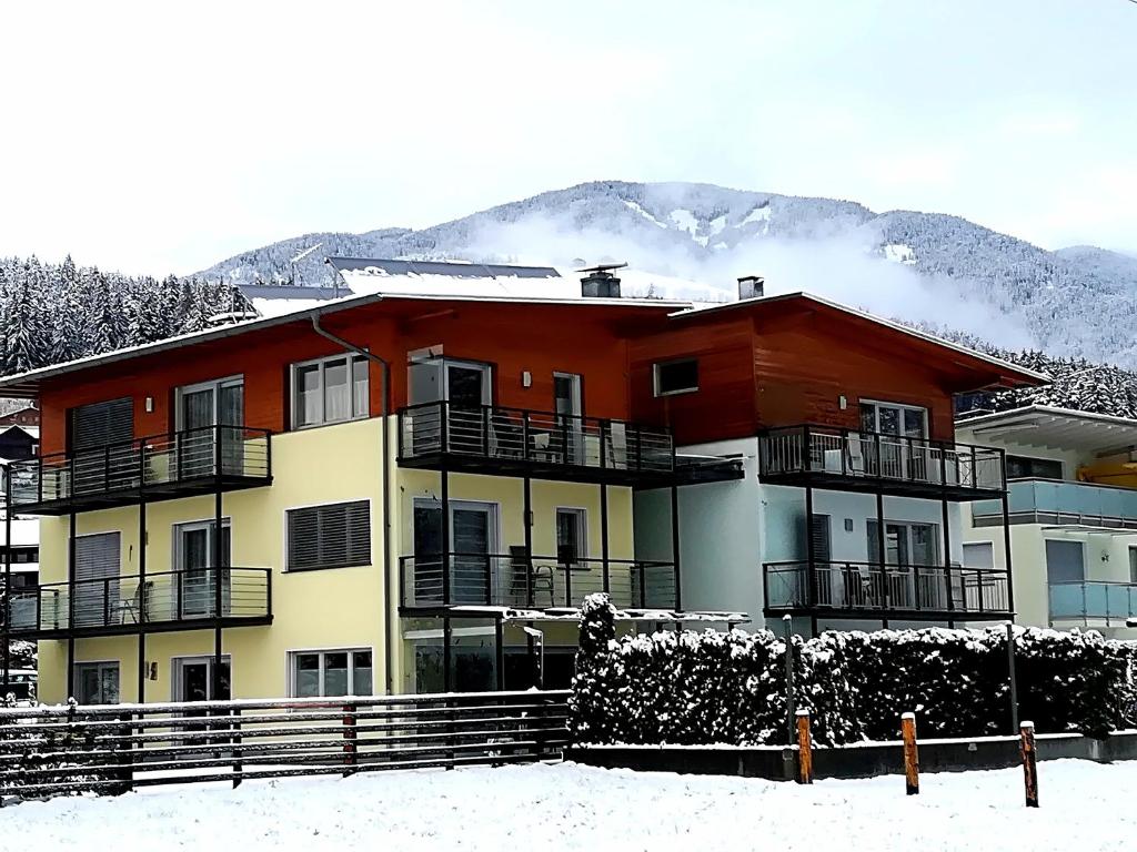 a building in the snow with a mountain in the background at Kronsun Percha in Perca