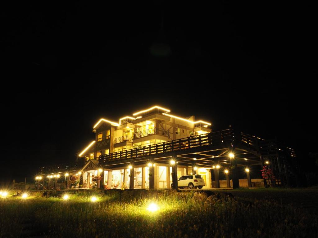 a house lit up at night with lights at Fully One B&amp;B in Taitung City
