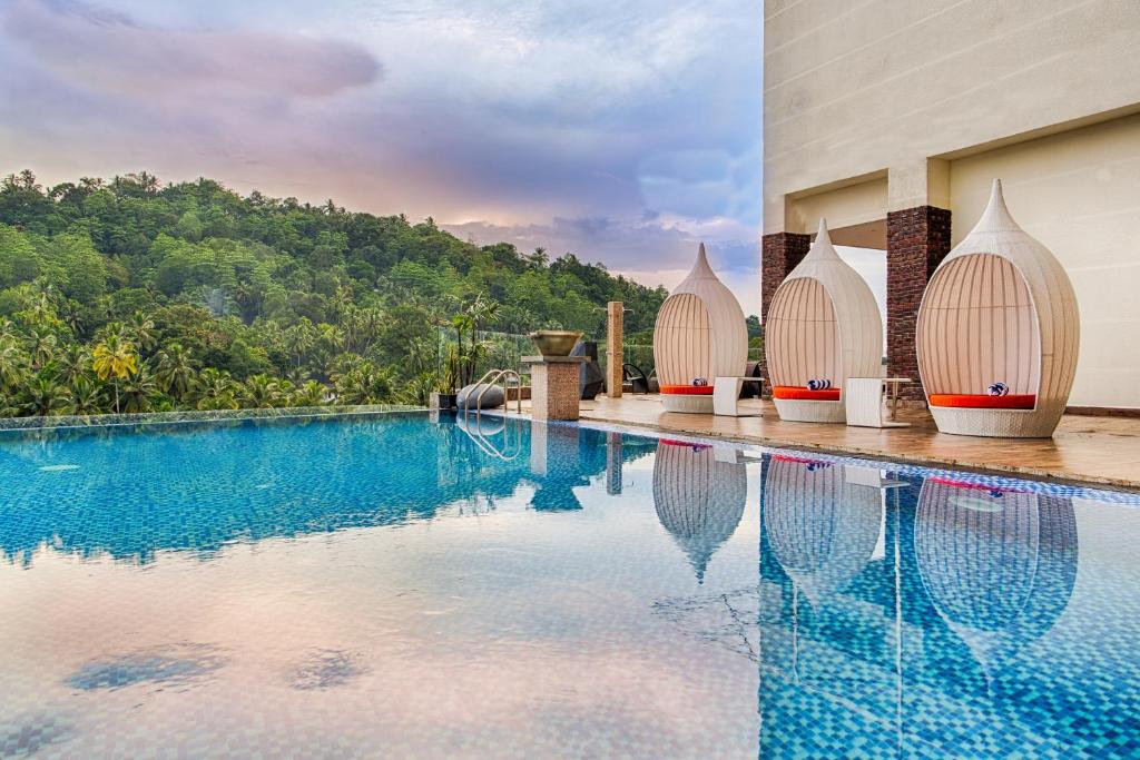 an image of a swimming pool at a resort at The Golden Crown Hotel in Kandy