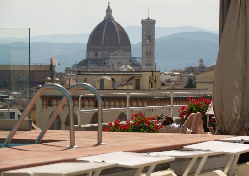a balcony with a view of a building with a clock tower at Hotel Kraft in Florence