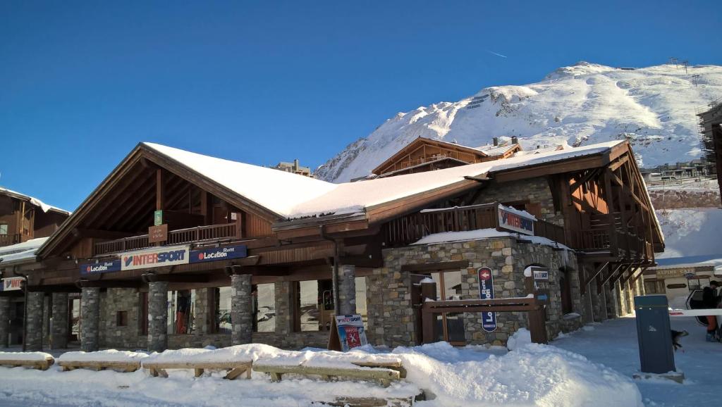 a ski lodge in the snow with a mountain at Les Suites du Val Claret in Tignes