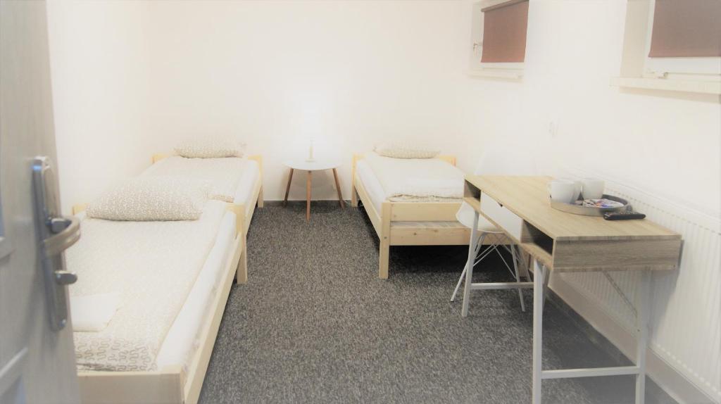 a hospital room with two beds and a desk at Noclegi u Andrzeja in Gdańsk