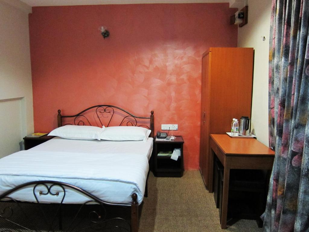 Postel nebo postele na pokoji v ubytování Oriental Inn