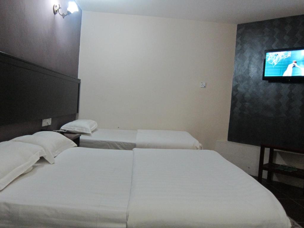 Postel nebo postele na pokoji v ubytování Oriental Inn