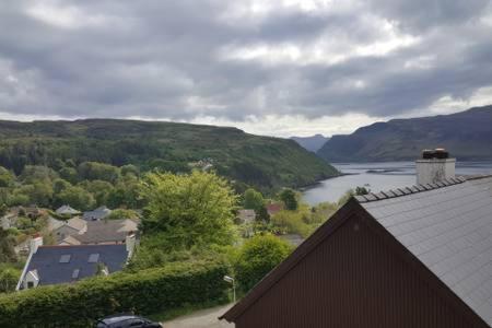 a view of a house with a view of a lake at Number 12 Self Catering in Portree