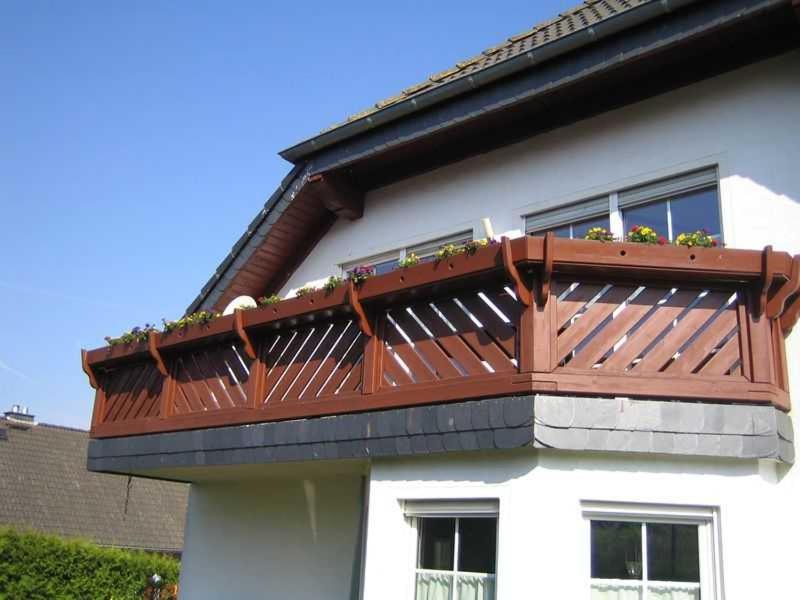 a wooden deck on the side of a house at Ferienwohnung Haus Andre _ fuer 4 in Ulmen
