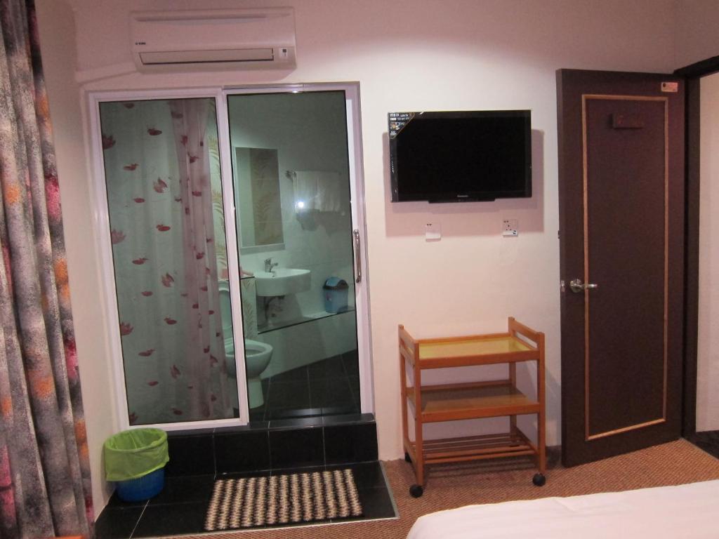 TV a/nebo společenská místnost v ubytování Oriental Inn
