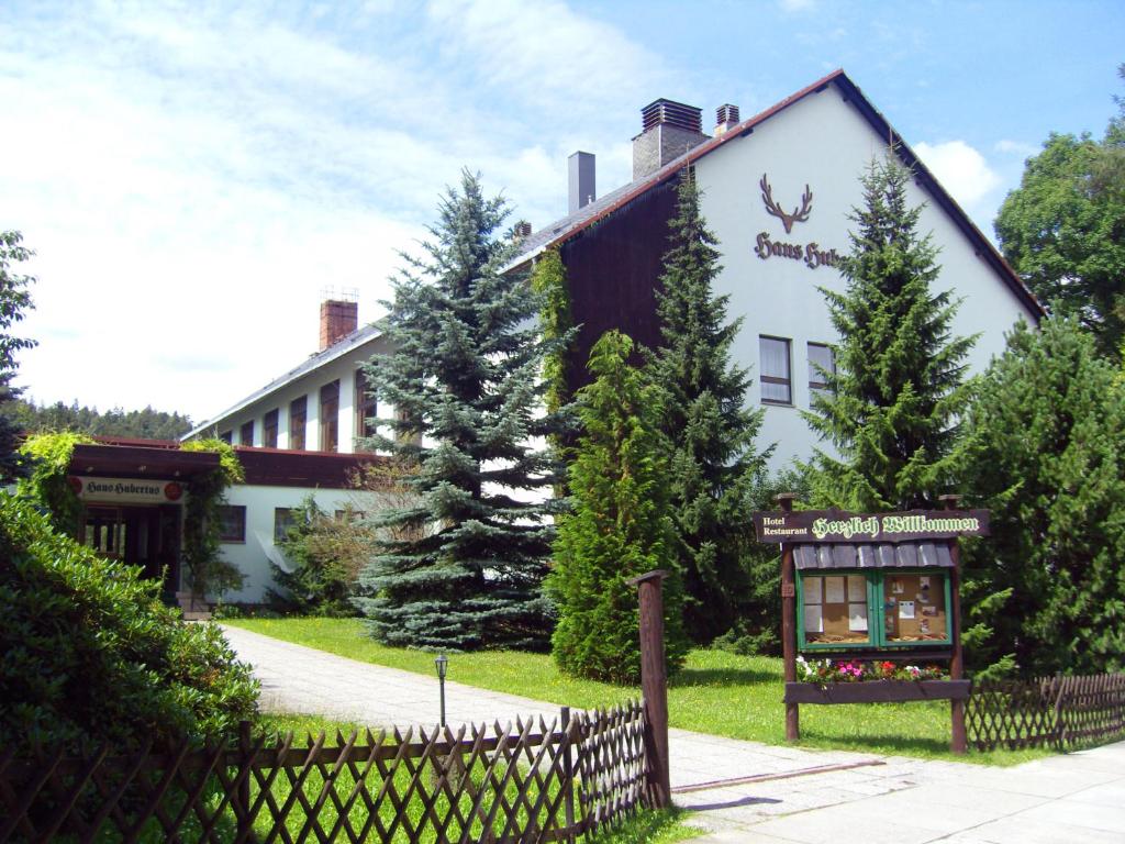 a building with a sign in front of it at Naturparkhotel Haus Hubertus in Oybin