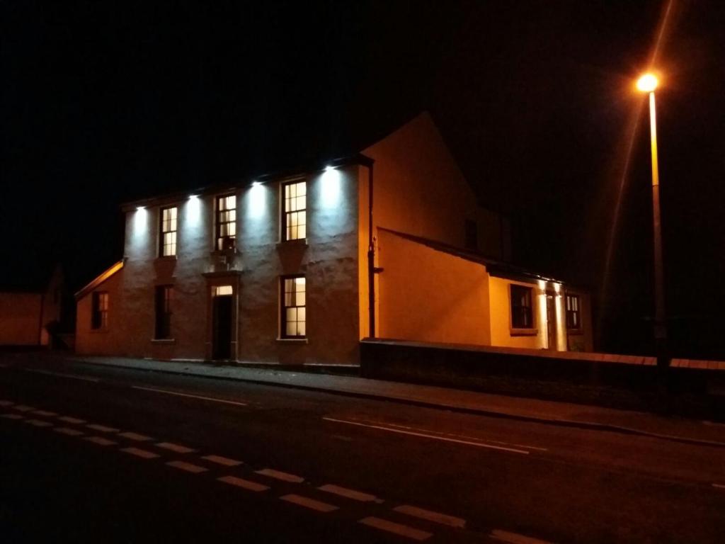 a building lit up at night with a street light at Saracens House in Preesall