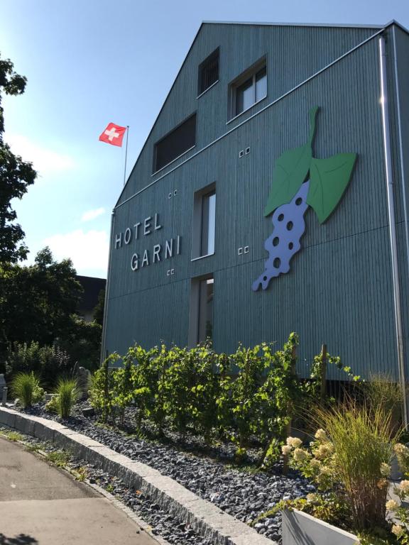 a building with a painting of a grape on it at Hotel Traube Garni in Küttigen