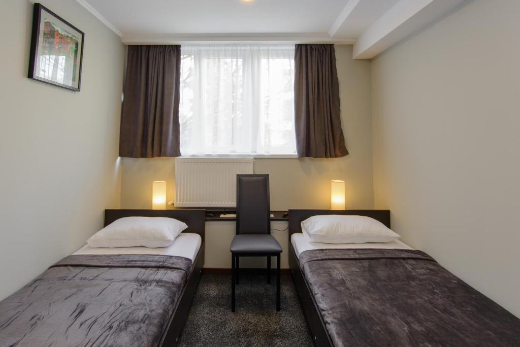 Postel nebo postele na pokoji v ubytování Hotel Reverence