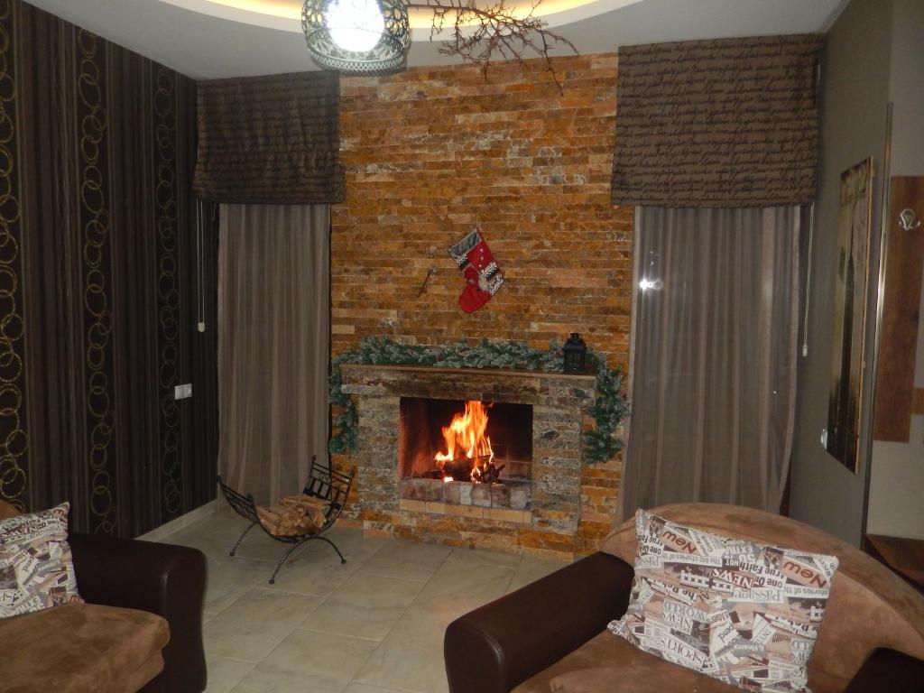a fireplace in a living room with a fire place at Cottage Sunny Side in Bakuriani