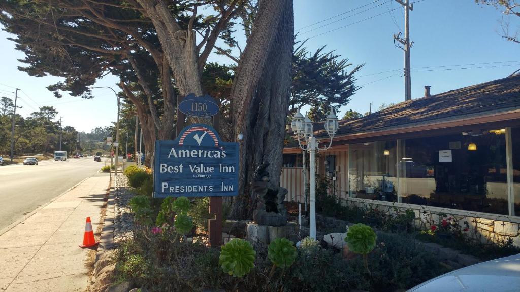 ein Schild für ein antiquarisches Gasthaus auf einer Straße in der Unterkunft Americas Best Value Presidents Inn on Munras in Monterey