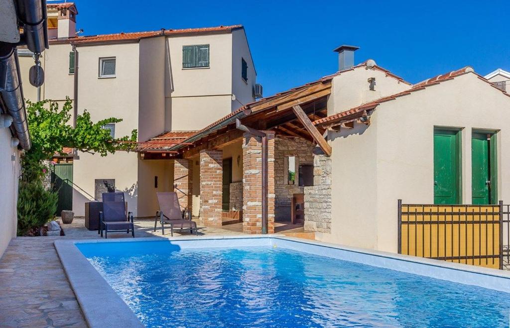 a villa with a swimming pool and a house at Villa Teresa in Medulin