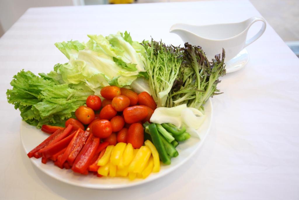 a plate of vegetables on a white table at New Space Hotel Airport in Ho Chi Minh City