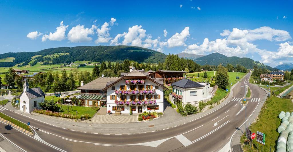 a large building on the side of a road at Hotel Gratschwirt in Dobbiaco