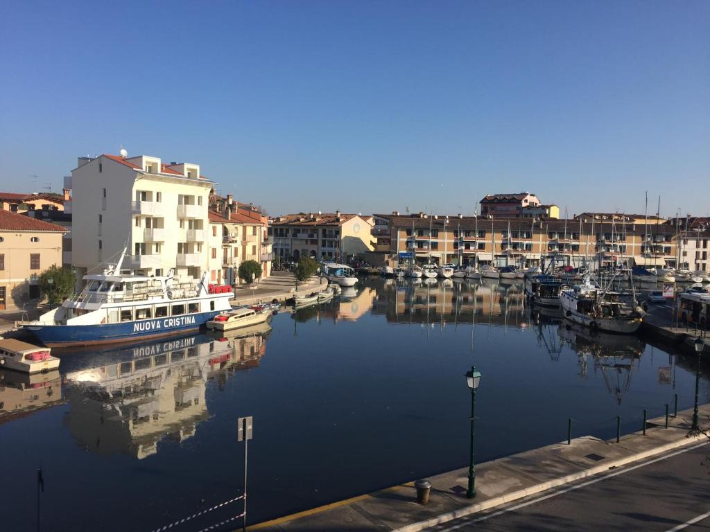 a group of boats docked in a harbor with buildings at Old Harbour House in Grado