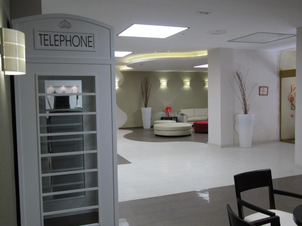 a lobby with a waiting room with a sign that reads telephone at Don Juan in Granada