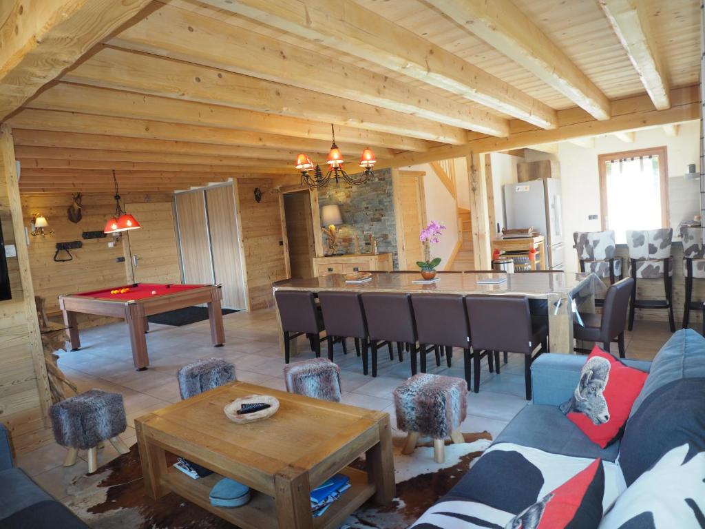 a living room with a table and a dining room at Les flocons in Crest-Voland