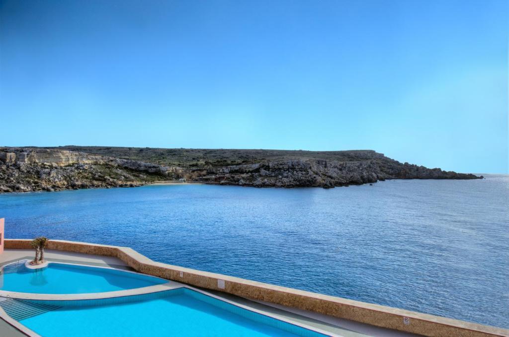 a view of the ocean from a resort pool at Paradise Bay Resort in Mellieħa