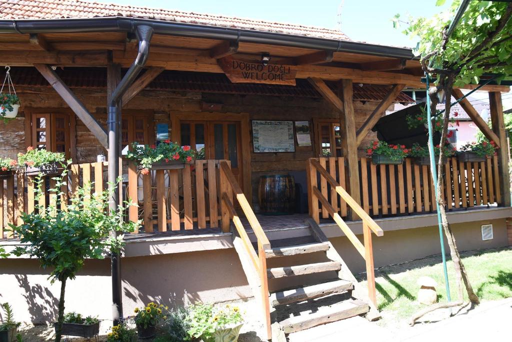 a wooden cabin with stairs leading to a porch at Holiday Homes 4N in Gornje Jesenje