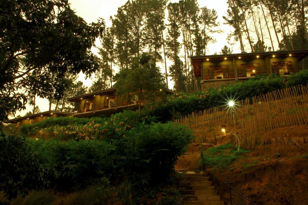 a house sitting on top of a hill with a staircase at Rowinrich Cottages in Ella