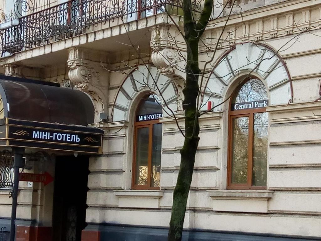 a building with a tree in front of it at Mini Hotel Central Park in Lviv