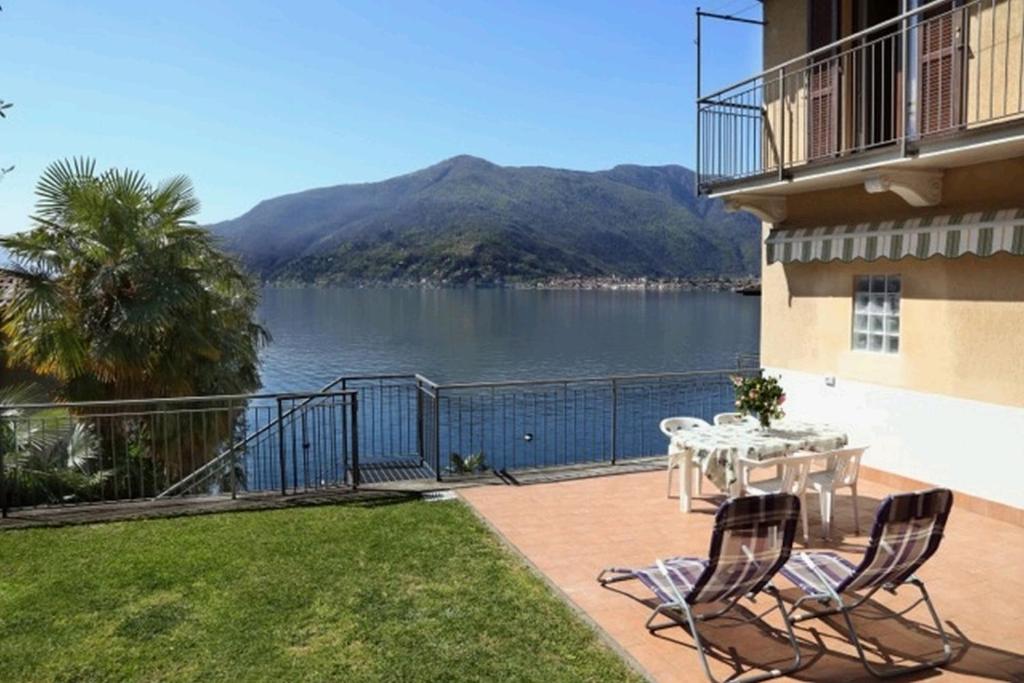 a balcony with a table and chairs and a view of a lake at Casa Riva in Poggio
