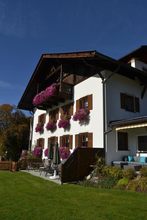 a white building with flowers on the balcony at Gästehaus Fitsch in Obsteig