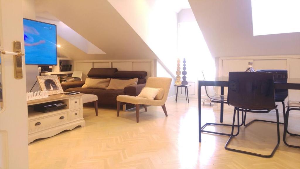 a living room with a couch and a tv at 3M VUT 519 As in Gijón